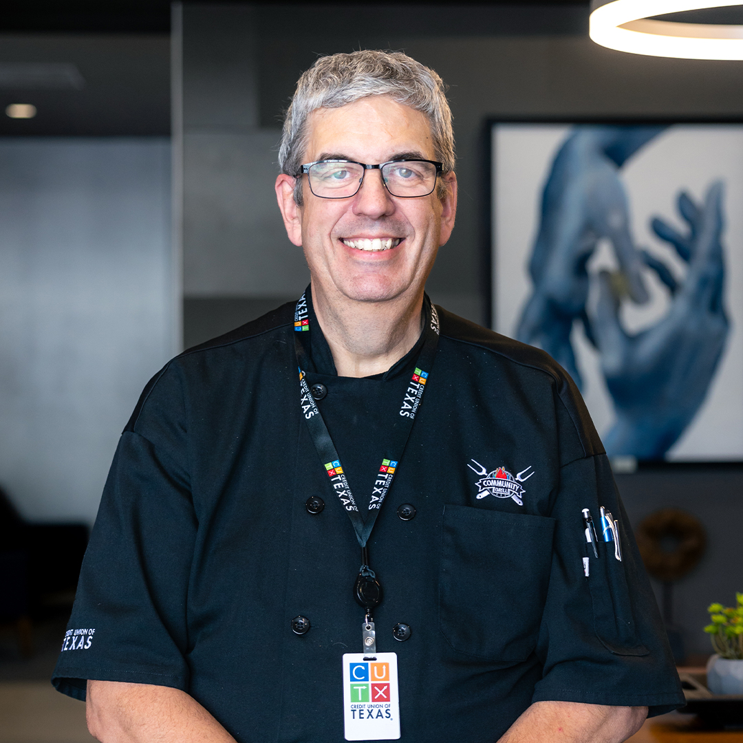 image of CUTX food truck chef wearing a black apron