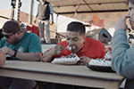 People competing in a pie eating contest