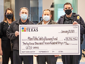 Four people holding and oversized check that is written out to the Allen Public Safety Recovery Fund