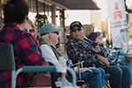 A group of people sitting out on the Gilmer, TX town square